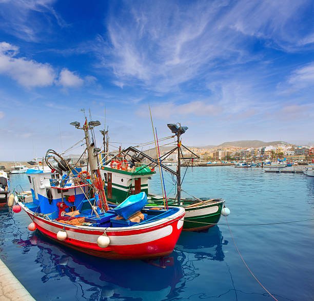 Colorful fishing boats on the pier in Amalfi coast, Italy. Mediterranean sea coast. Famous travel destination.