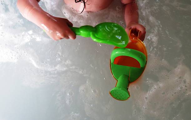 istock little girl playing with a spoon and a bucket 475344694