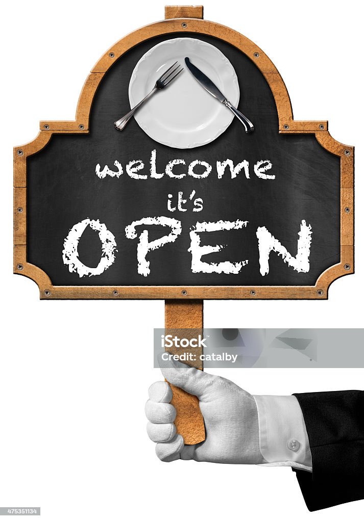 Welcome it is Open - Sign with Hand of Waiter Hand of waiter with glove holding a pole and blackboard with text, Welcome it is open, white plate and silver cutlery. Isolated on white background 2015 Stock Photo