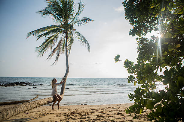 istock Young woman on the beach using a digital tablet-Outdoors 475353859