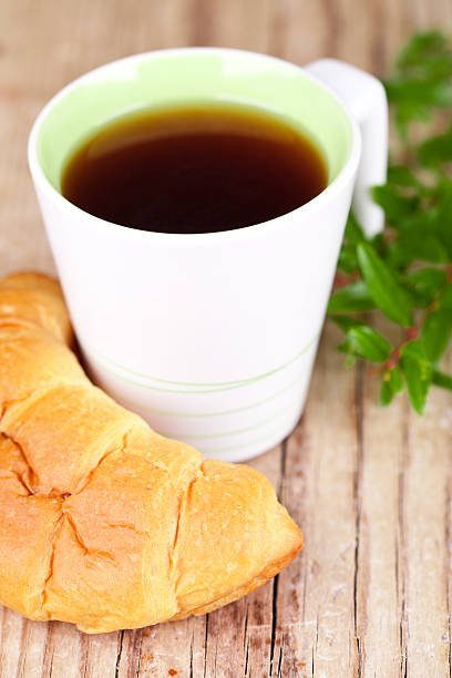 istock cup of tea and fresh croissant 475354869