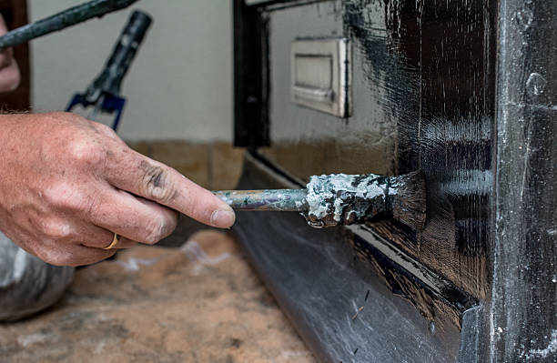 istock House painter  painting bottom of  front door 475356858