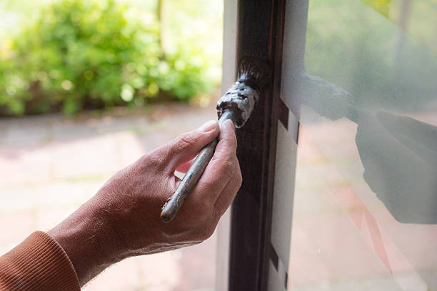 istock House painter  painting front door frame antique house from 1930 475356894