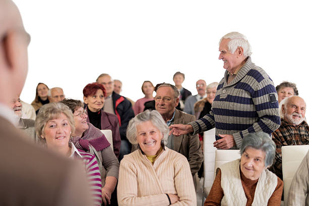 istock Smiling senior man talking on a seminar. Isolated on white. 475357034