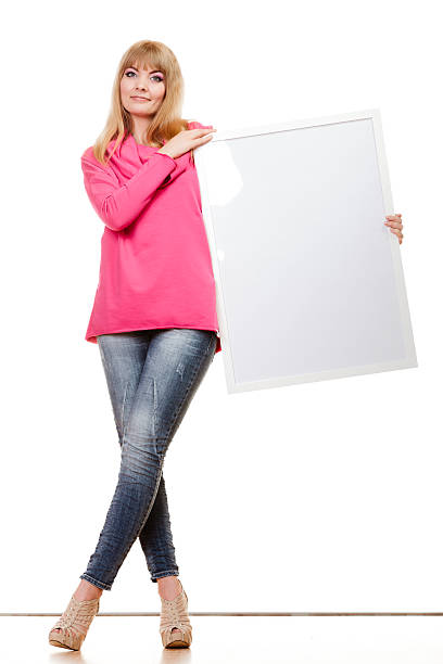 istock woman holding blank presentation board 475359262