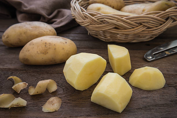 istock Potato and slices on wooden table 475359550