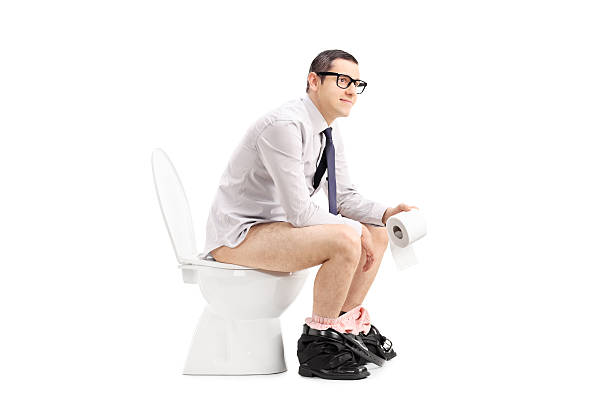 istock Young man sitting on a toilet 475360250