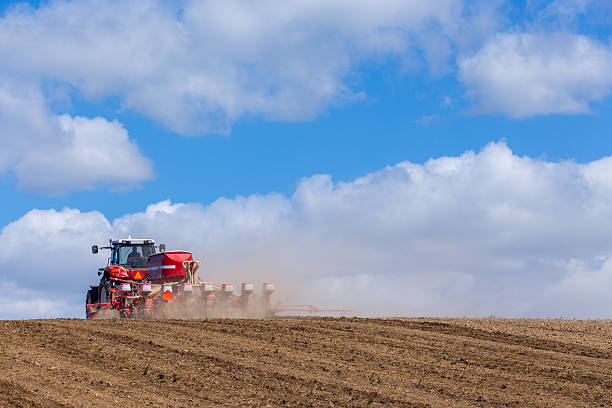 istock Tractor harrowing the field 475360800