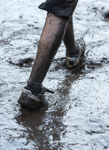 Mud-covered running in striongman mud run