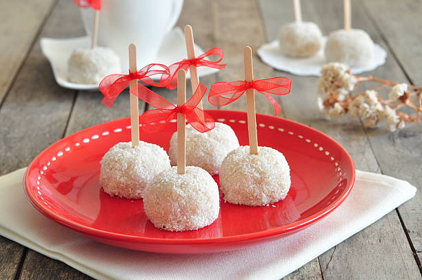 Sweet Cookies with gum on red plate and wood table.