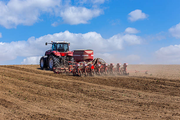 istock Tractor harrowing the field 475361278