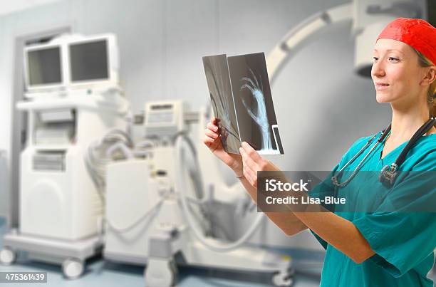 Doctor Examining Xray Stock Photo - Download Image Now - Data, Doctor, Examining