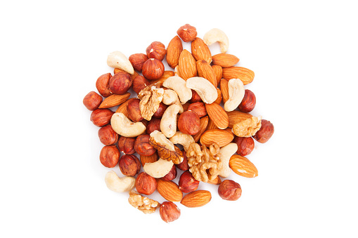 Mixed Nuts. Big pile of different nuts lying  on a white background.