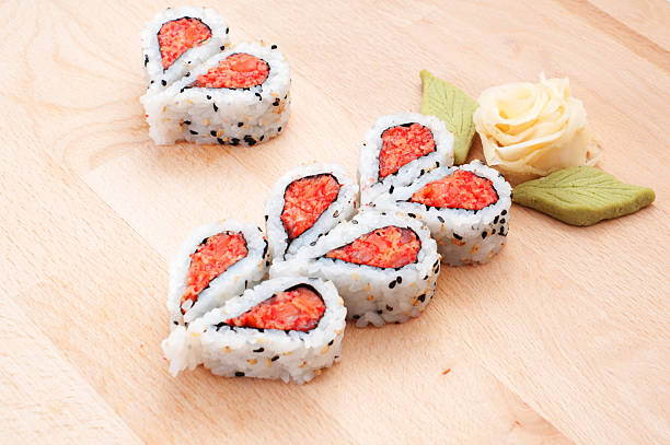 Sushi forming hearts and flower shapes on wooden cutting board