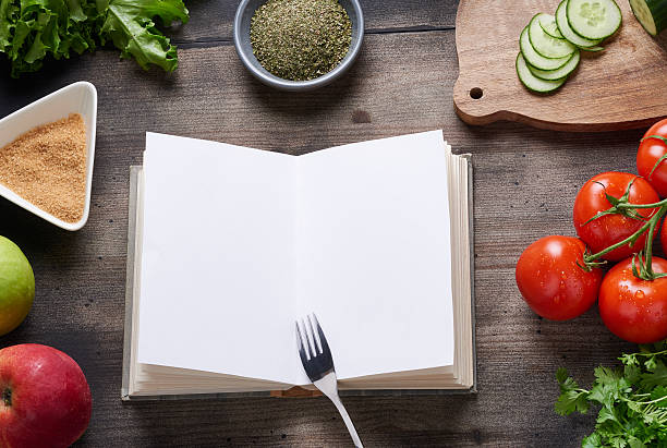 istock Cooking book on wooden table 475374078