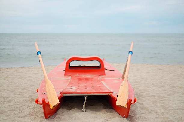 istock Colorful lifeboat on the empty beach, overcast day 475374726