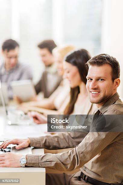 Smiling Young Businessman On A Meeting Looking At Camera Stock Photo - Download Image Now