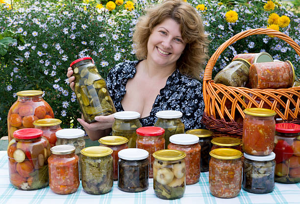 istock Woman with home canning for the winter 475377511