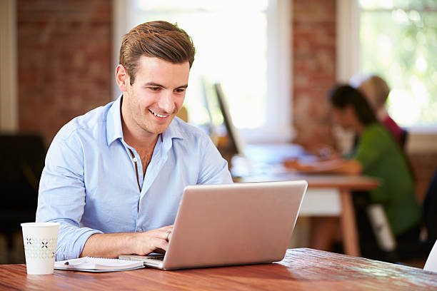 istock Man Working At Laptop In Contemporary Office 475380131