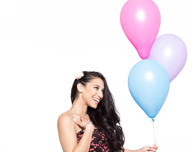 Attractive Young Smiling Brunette holding Colorful Balloons stock photo