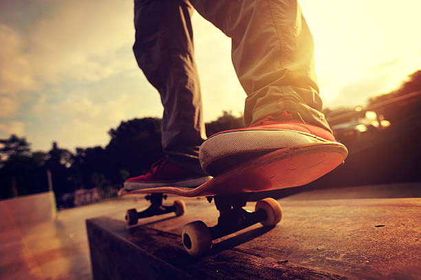 skateboarding legs sunrise skatepark stock photo