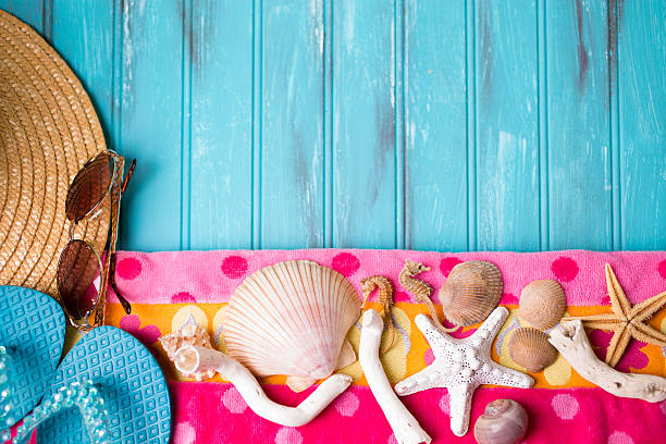 istock Summer vacation scene. Seashells, sandals on beach towel. Blue background. 475382796