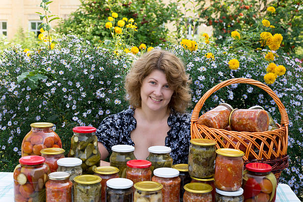 istock Woman with home canning for the winter 475383431
