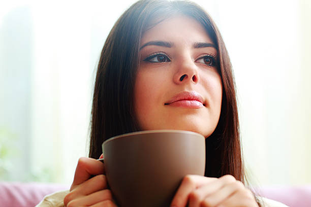 istock young thoughtful woman with cup of coffee 475384859