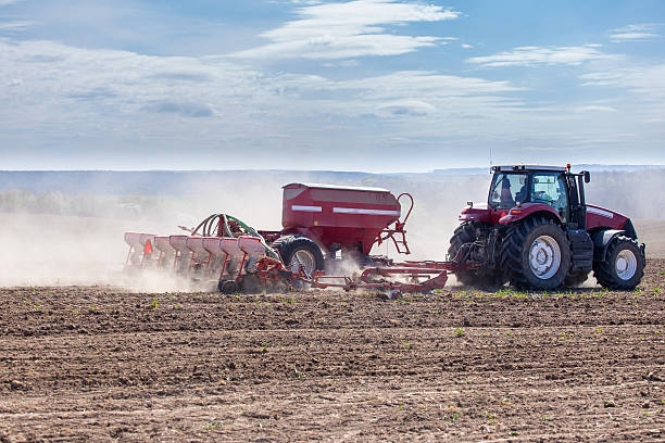 istock Tractor harrowing the field 475395706