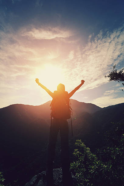 istock young woman hiker open arms moutain peak 475396176