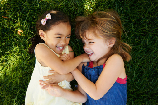 High angle shot of two little girls playing on the grass