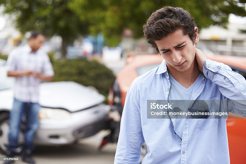 Teenage Driver Suffering Whiplash Injury Traffic Accident Teenage Driver Suffering Whiplash Injury Traffic Accident Rubbing Neck With Hand. Physical Injury Stock Photo