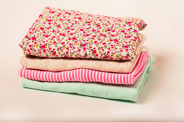 istock Pile of colorful clothes over white background 475397751