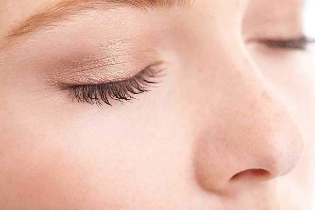 She likes to keep her make-up natural Closeup studio shot of a model with her eyes closed blinking stock pictures, royalty-free photos & images