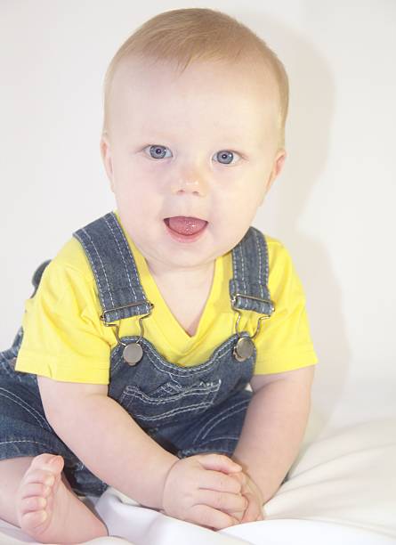 Cute baby boy wearing in jeans dungaree