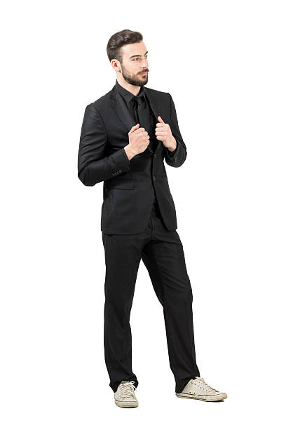 istock Successful young bearded businessman wearing sneakers looking away 475402642