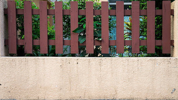 istock wall and wooden fence besiege home 475402881