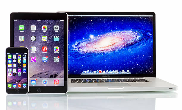 Apple Macbook Pro, iPad Air 2 and iPhone 6 Galati, Romania - December 08, 2014: Apple  Macbook Pro, iPad Air 2 and iPhone 6 on white background. All devices displaying home screen and produced by Apple Inc. apple device stock pictures, royalty-free photos & images