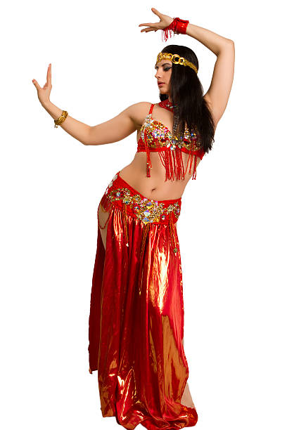 Beautiful young girl in a red suit oriental dance in motion isolated on white background