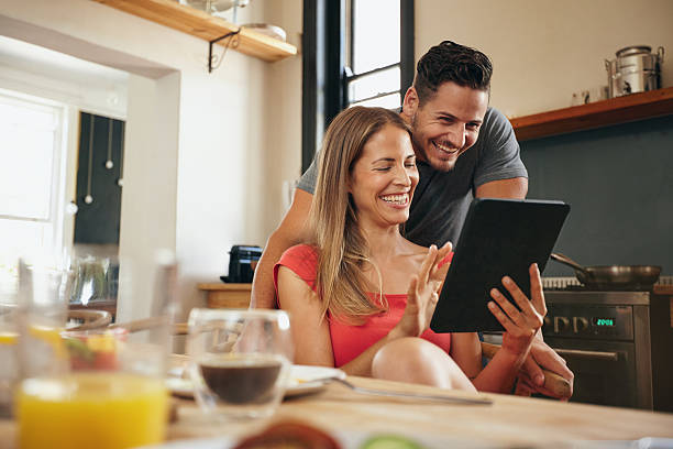 istock Happy young couple using a digital tablet in morning 475405482