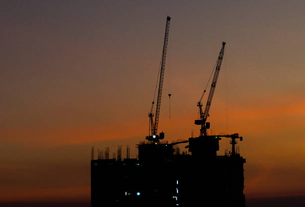 istock mobile crane at roof floor, silhouettes sunset 475407135