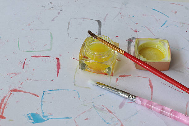 istock paint on a dirty canvas with brushes 475407960