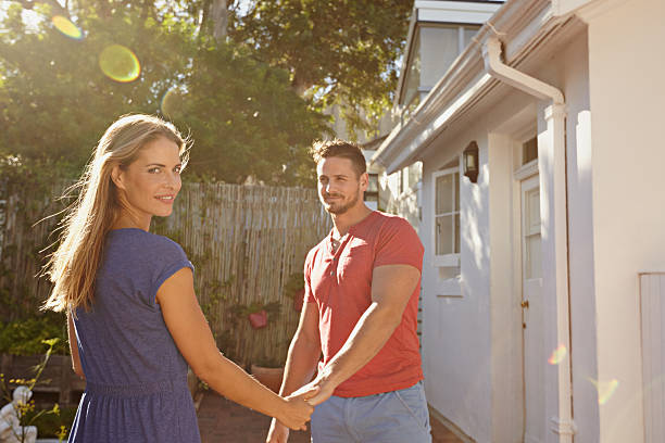 istock Beautiful young couple outside their house 475408196