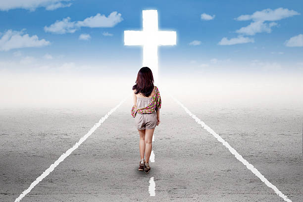 istock Girl doing a holy trip to the cross 475410454