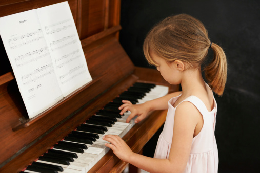 Cropped shot of a little girl playing the piano