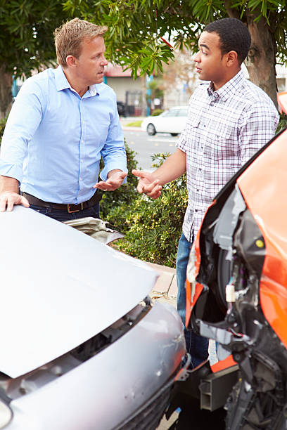 istock Two Drivers Inspecting Damage After Traffic Accident 475412175