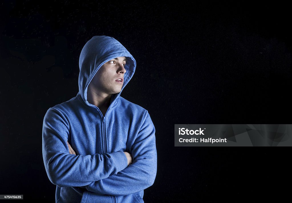 Fitness man Young fitness fashion model is posing in studio on black background. Activity Stock Photo