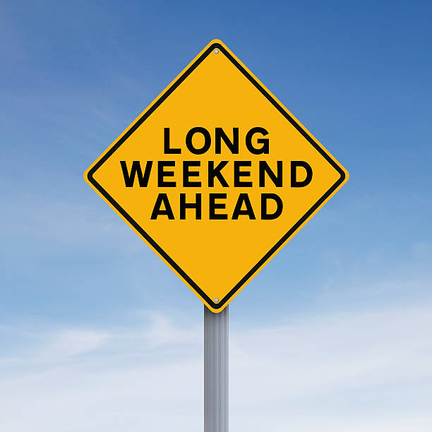 Long Weekend Ahead Conceptual road sign indicating Long Weekend Ahead city break photos stock pictures, royalty-free photos & images