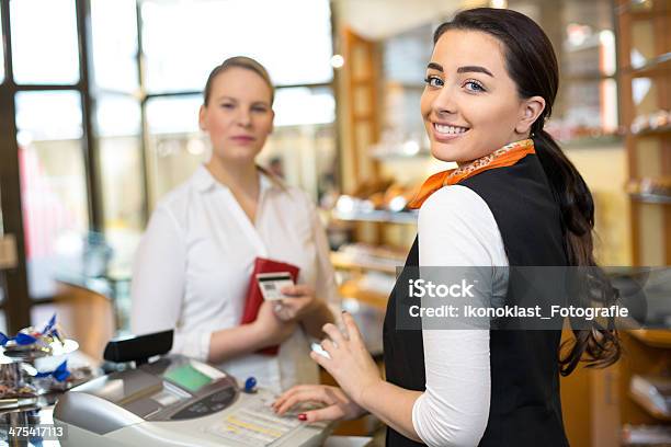 Client In Shop Paying At Cash Register Stock Photo - Download Image Now - Saleswoman, Store, Cashier