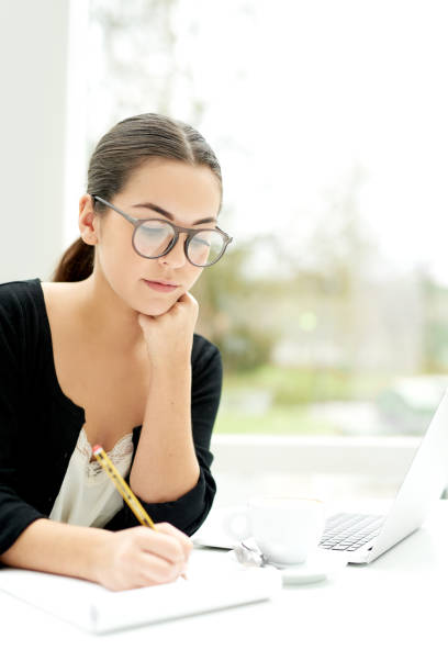 istock Young businesswoman working in a bright office 475417258